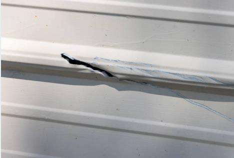 aluminum siding with large gash