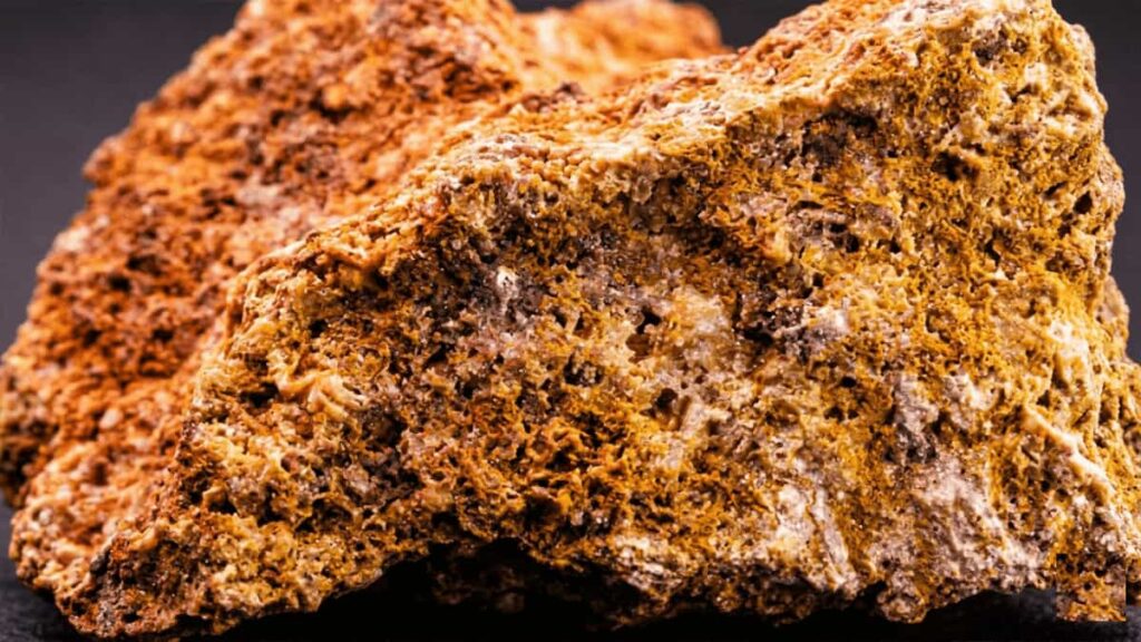 Raw bauxite ore showing reddish-brown pisolitic structure, the primary source of aluminum production
