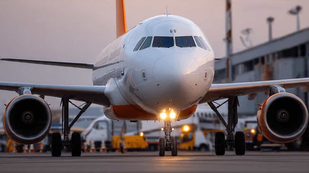 A commercial airliner's fuselage and engine, highlighting the use of aluminum alloys in aircraft body construction.