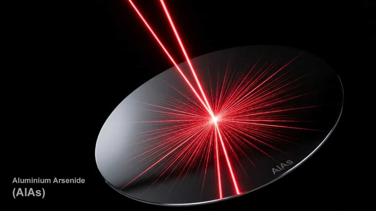 High-resolution dramatic photograph of a bright red laser beam striking a reflective aluminum arsenide wafer.