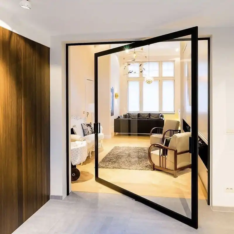 Minimalist black frame aluminum interior pivot door dividing a hallway and a luxury living room.